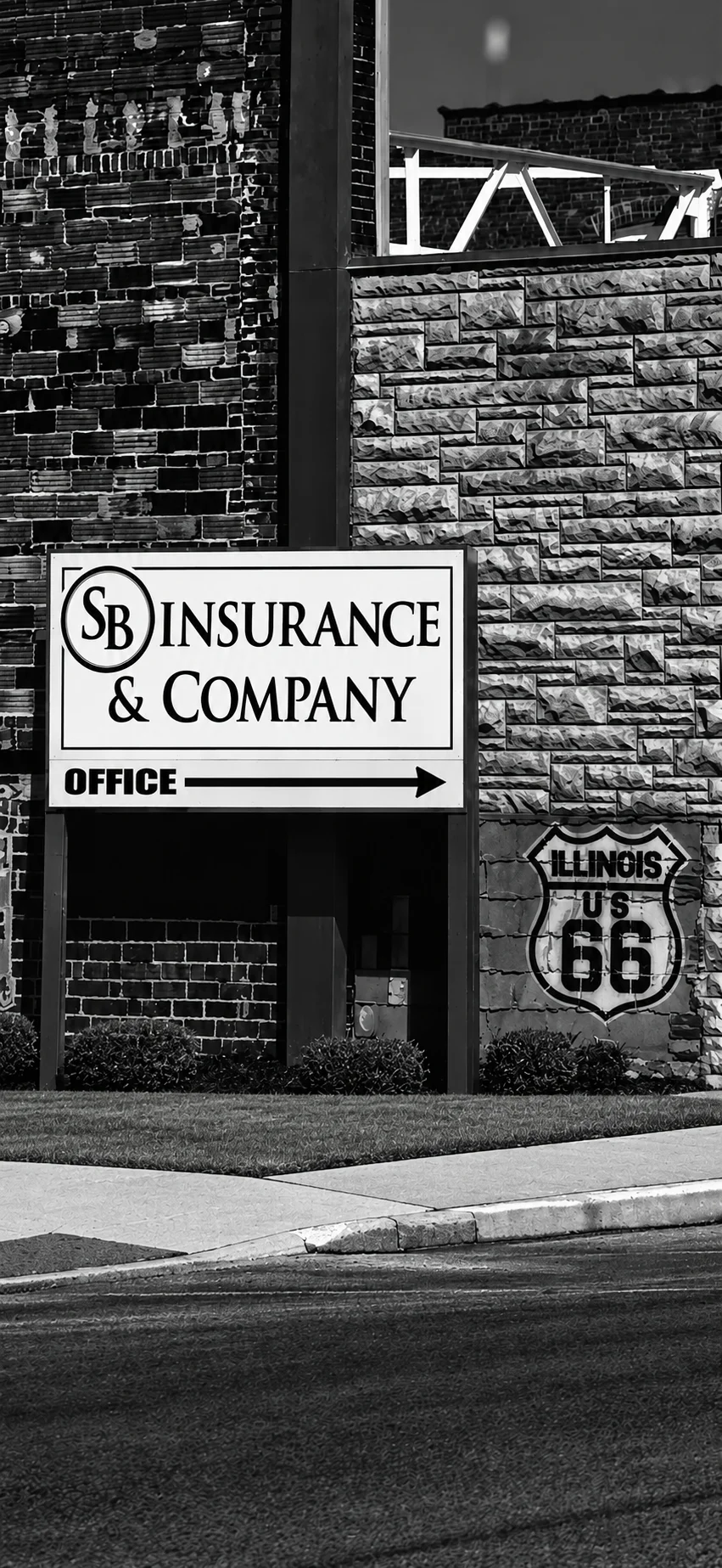 SB Insurance & Company office sign next to the Illinois Route 66 shield in Virden, Illinois